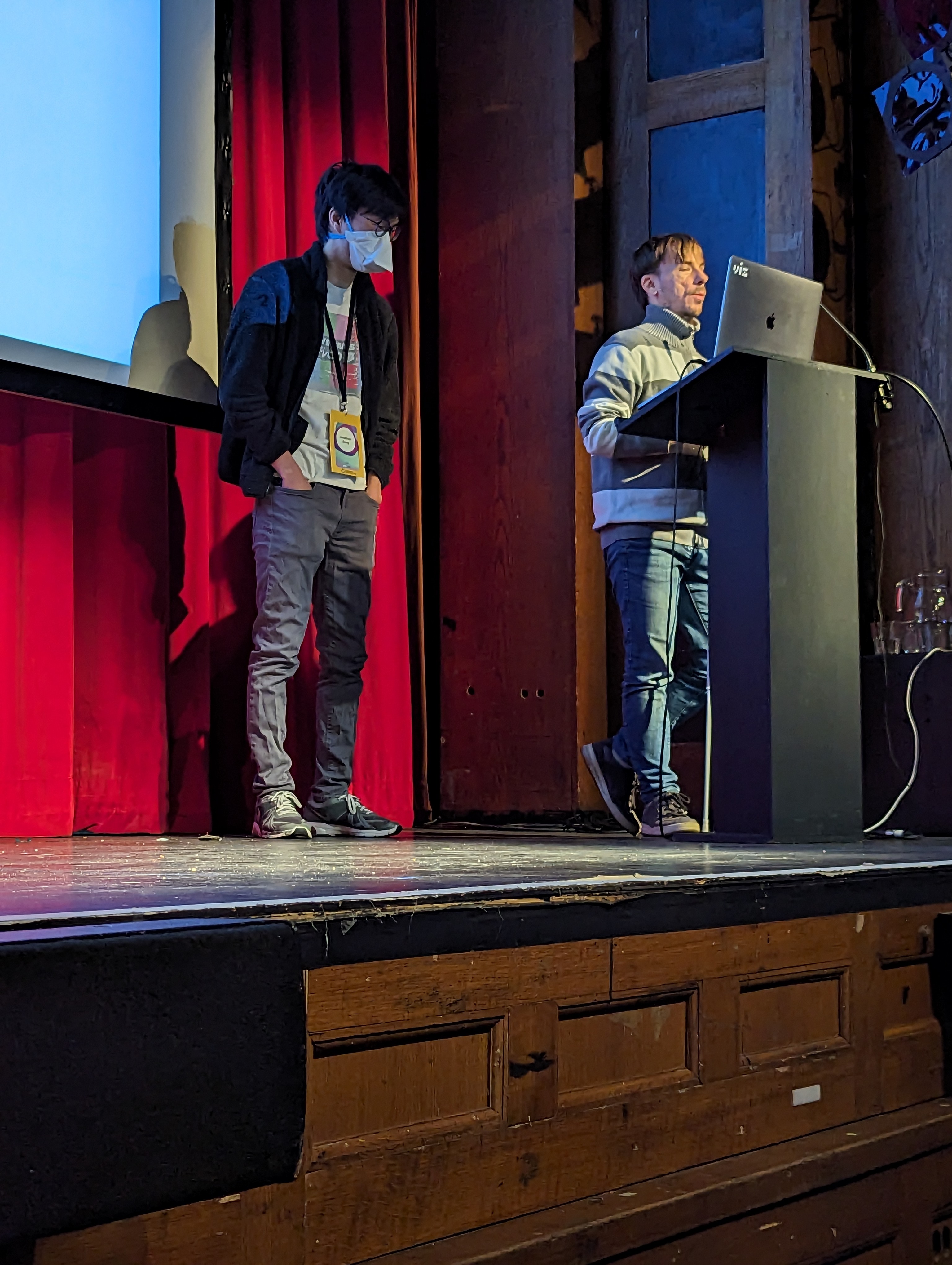 Daniel and Jonathan are presenting on a conference stage.